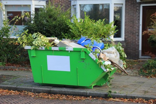 Construction workers using a skip in Barking